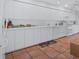 Spacious kitchen with all-white cabinetry, a white countertop, tiled flooring and modern appliances at 3160 Whispering Pines Ct, Spring Hill, FL 34606