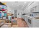 Bright kitchen with white cabinetry, stainless steel appliances, terra cotta flooring, and ample storage space at 3160 Whispering Pines Ct, Spring Hill, FL 34606