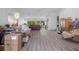 Bright living room featuring hardwood floors, ample space, and a seamless flow to outdoor views at 3160 Whispering Pines Ct, Spring Hill, FL 34606