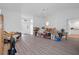 Spacious living area boasts a modern chandelier, laminate flooring, and bright natural light at 3160 Whispering Pines Ct, Spring Hill, FL 34606