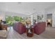 Bright and open living room with sliding glass doors to the yard, built-in shelving, and grey wood-look flooring at 3160 Whispering Pines Ct, Spring Hill, FL 34606