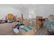 Bright living room with a modern chandelier and abundant space for versatile use at 3160 Whispering Pines Ct, Spring Hill, FL 34606