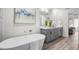 Modern bathroom featuring a soaking tub, double vanity, and gray cabinets at 3416 Lema Dr, Spring Hill, FL 34609