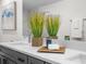 Elegant bathroom with double vanity, quartz countertop, and decorative accents at 3416 Lema Dr, Spring Hill, FL 34609