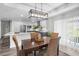 Bright dining area featuring modern light fixture, and wicker chairs, adjacent to an open kitchen at 3416 Lema Dr, Spring Hill, FL 34609