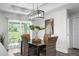 Cozy dining area with a modern light fixture and sliding glass doors that lead to the backyard at 3416 Lema Dr, Spring Hill, FL 34609