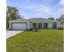 Charming single-story home with a well-manicured lawn, attached two-car garage, and inviting curb appeal at 3416 Lema Dr, Spring Hill, FL 34609