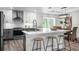 Bright, modern kitchen with stainless steel appliances and a large island with bar seating at 3416 Lema Dr, Spring Hill, FL 34609
