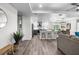 Spacious open-concept living room featuring modern gray vinyl floors, updated kitchen, and recessed lighting at 3416 Lema Dr, Spring Hill, FL 34609