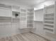 Spacious walk-in closet featuring custom shelving and ample storage space at 3416 Lema Dr, Spring Hill, FL 34609