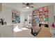 Bedroom with a large window, desk and chair, shelving unit filled with stuff animals at 4004 Autumn Amber Dr, Spring Hill, FL 34609