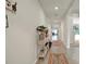 Inviting hallway features neutral paint, ceramic tile, and decor with a view of the living spaces at 4004 Autumn Amber Dr, Spring Hill, FL 34609