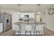 Modern kitchen island with pendant lights, granite countertop, breakfast bar seating, and stainless steel appliances at 4004 Autumn Amber Dr, Spring Hill, FL 34609