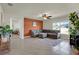 Inviting living room with a gray sectional sofa, ceiling fan, natural light, and open access to other rooms at 4004 Autumn Amber Dr, Spring Hill, FL 34609