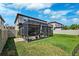 Lush backyard featuring a well-maintained lawn and a screened patio, great for outdoor activities at 4012 Dragonfly Trl, Odessa, FL 33556