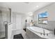 Bright bathroom with a large soaking tub and a separate glass-enclosed shower at 4012 Dragonfly Trl, Odessa, FL 33556