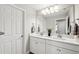 Bright bathroom with a double sink vanity, large mirror, and updated fixtures at 4012 Dragonfly Trl, Odessa, FL 33556