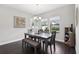 Sunlit dining room with a stylish table setting, complemented by elegant decor and comfortable seating for Gathering meals at 4012 Dragonfly Trl, Odessa, FL 33556