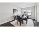 Modern dining room with wood table, decorative rug, wainscotting, and a decorative painting at 4012 Dragonfly Trl, Odessa, FL 33556