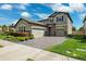 Beautiful two-story home featuring a tile roof, a three-car garage, and lush landscaping at 4012 Dragonfly Trl, Odessa, FL 33556