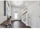 Bright foyer features a decorative wreath on the front door, hard wood floors, and a staircase at 4012 Dragonfly Trl, Odessa, FL 33556