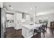 Bright kitchen features white cabinets, stainless appliances, marble countertops, an island and a dining area at 4012 Dragonfly Trl, Odessa, FL 33556