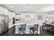 Spacious kitchen with a large central island, modern appliances, and adjacent dining area for Gathering meals and gatherings at 4012 Dragonfly Trl, Odessa, FL 33556