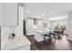 An open-concept kitchen displays white cabinets and a quartz countertop island with seating, blending style with functionality at 4012 Dragonfly Trl, Odessa, FL 33556