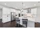 Modern kitchen boasts white cabinets, stainless steel appliances, and a large island, perfect for cooking and entertaining at 4012 Dragonfly Trl, Odessa, FL 33556