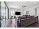 Comfortable living room with a large sofa, modern entertainment setup, and access to the outdoor area at 4012 Dragonfly Trl, Odessa, FL 33556