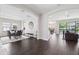 Open concept home with a living room, dining room, patio, hardwood floors, and neutral paint at 4012 Dragonfly Trl, Odessa, FL 33556