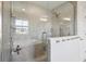 Modern bathroom featuring a glass-enclosed shower and a view of the soaking tub at 4012 Dragonfly Trl, Odessa, FL 33556