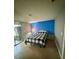 Inviting bedroom with a colorful accent wall, tile flooring, and a sliding glass door to the outdoor area at 4235 Sheldon Pl # 4235, New Port Richey, FL 34652