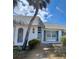 Charming condo features a well-maintained exterior with a mature palm tree, blue shutters and decorative window details at 4235 Sheldon Pl # 4235, New Port Richey, FL 34652