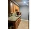 Well-equipped kitchen features granite countertops, wood cabinetry, and stainless steel sink at 4235 Sheldon Pl # 4235, New Port Richey, FL 34652