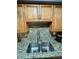 Close-up of the kitchen sink area, highlighting granite countertops and a stainless steel double basin sink at 4235 Sheldon Pl # 4235, New Port Richey, FL 34652