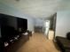 Open-concept living space with tile flooring, flowing seamlessly into the adjacent dining area for easy entertaining at 4235 Sheldon Pl # 4235, New Port Richey, FL 34652