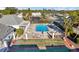 Overhead angle of a community pool; includes sun-loungers, surrounding greenery and nearby parking at 4235 Sheldon Pl # 4235, New Port Richey, FL 34652