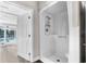 Bathroom with a white shower and glass doors leads to the living area and the pool at 4503 Jacona Dr, Hernando Beach, FL 34607