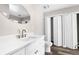 Bathroom featuring a modern white vanity with gold fixtures, and bi-fold closet at 4503 Jacona Dr, Hernando Beach, FL 34607