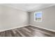 Cozy bedroom features hardwood floors and a window with a view at 4503 Jacona Dr, Hernando Beach, FL 34607