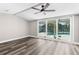 Bright bedroom with sliding glass doors and hardwood floors offers a tranquil retreat with outdoor access at 4503 Jacona Dr, Hernando Beach, FL 34607