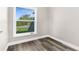 Bedroom featuring new flooring and a window for plenty of natural light at 4503 Jacona Dr, Hernando Beach, FL 34607