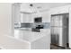 Modern kitchen with stainless steel appliances, white cabinets, and stylish backsplash offers an efficient cooking space at 4503 Jacona Dr, Hernando Beach, FL 34607