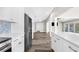 Open kitchen featuring stainless steel appliances, white cabinets, and ample countertop space at 4503 Jacona Dr, Hernando Beach, FL 34607