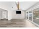 Open living room with wood floors and a view of the pool through sliding doors at 4503 Jacona Dr, Hernando Beach, FL 34607