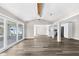 Spacious living room with hardwood floors, ceiling fan, and sliding glass doors offers seamless indoor-outdoor living at 4503 Jacona Dr, Hernando Beach, FL 34607