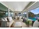 Relaxing screened-in patio area is furnished for dining and lounging near the pool, creating a lovely outdoor experience at 4503 Jacona Dr, Hernando Beach, FL 34607