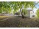 Backyard view featuring a screened porch and shade trees at 4559 Crescent Rd, Spring Hill, FL 34606