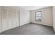 Bedroom with a closet featuring folding doors, carpet, and a window at 4559 Crescent Rd, Spring Hill, FL 34606